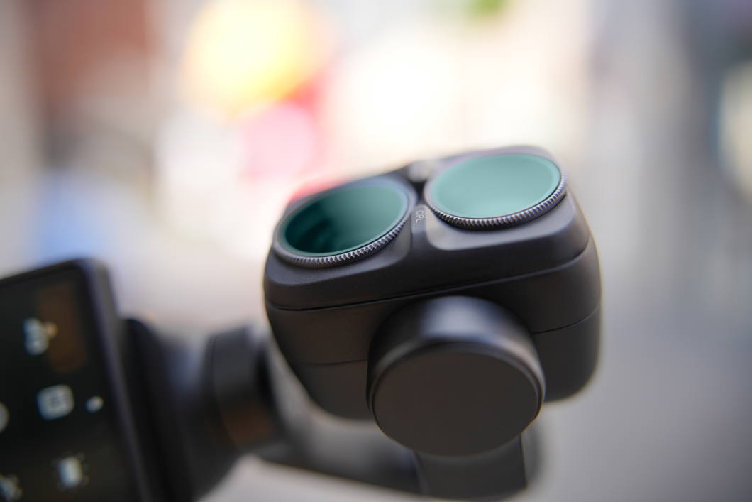 Närbild på kamerahuvudet på en DJI Osmo Pocket 4 Pro med NiSi-filter, gata i bakgrunden