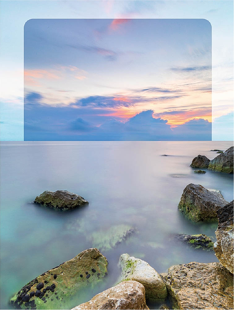 Klippor i havet vid solnedgång där ett Hard GND-filter mörkar himlen